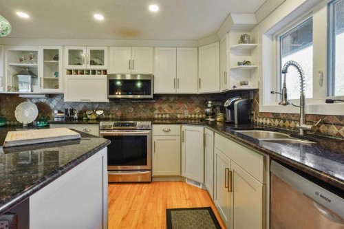 121S 100W, Raymond, AB - Indoor Photo Showing Kitchen With Stainless Steel Kitchen With Double Sink