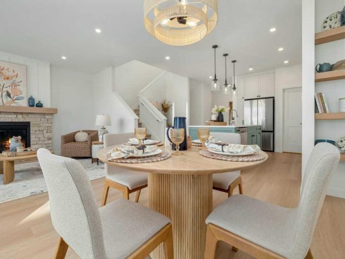 3028 21 Street, Coaldale, AB - Indoor Photo Showing Dining Room With Fireplace