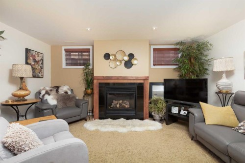 80 Canyon Boulevard West, Lethbridge, AB - Indoor Photo Showing Living Room With Fireplace