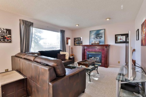2727 7A Avenue North, Lethbridge, AB - Indoor Photo Showing Living Room With Fireplace