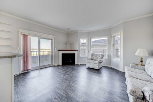 103-6 Skyline Crescent, Claresholm, AB - Indoor Photo Showing Living Room With Fireplace