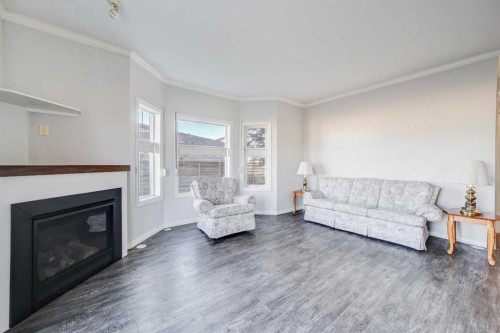 103-6 Skyline Crescent, Claresholm, AB - Indoor Photo Showing Living Room With Fireplace