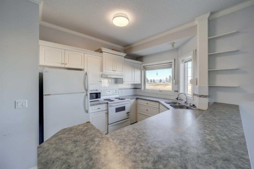 103-6 Skyline Crescent, Claresholm, AB - Indoor Photo Showing Kitchen With Double Sink