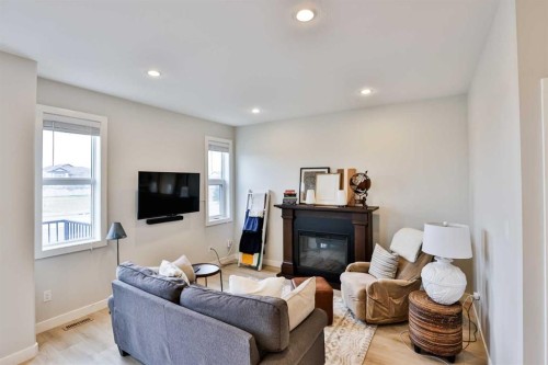 4-73 Aquitania Circle West, Lethbridge, AB - Indoor Photo Showing Living Room With Fireplace