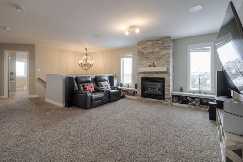 541 Aquitania Boulevard West, Lethbridge, AB - Indoor Photo Showing Living Room With Fireplace