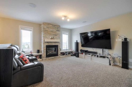 541 Aquitania Boulevard West, Lethbridge, AB - Indoor Photo Showing Living Room With Fireplace