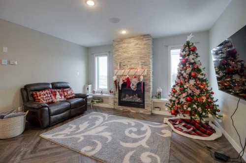 541 Aquitania Boulevard West, Lethbridge, AB - Indoor Photo Showing Living Room With Fireplace