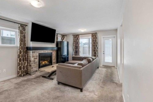 207 Moonlight Cove West, Lethbridge, AB - Indoor Photo Showing Living Room With Fireplace