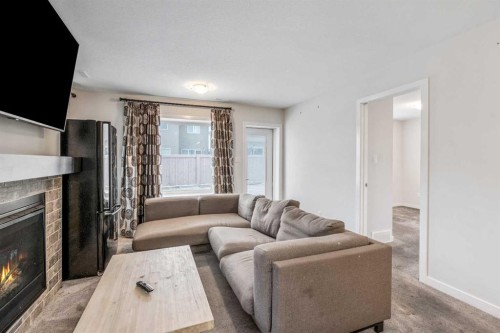 207 Moonlight Cove West, Lethbridge, AB - Indoor Photo Showing Living Room With Fireplace