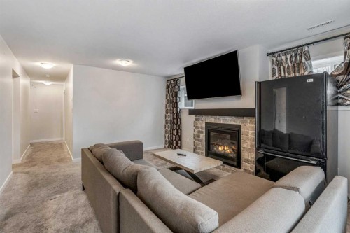 207 Moonlight Cove West, Lethbridge, AB - Indoor Photo Showing Living Room With Fireplace