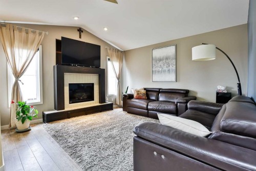 93 Riverine Lane West, Lethbridge, AB - Indoor Photo Showing Living Room With Fireplace