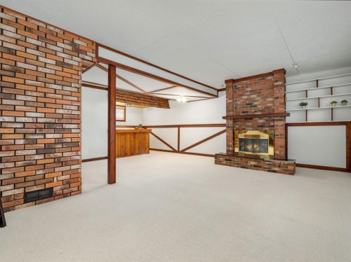1102 Cameron Road South, Lethbridge, AB - Indoor Photo Showing Other Room With Fireplace