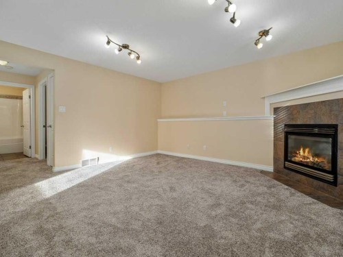 468 Heritage Boulevard West, Lethbridge, AB - Indoor Photo Showing Other Room With Fireplace