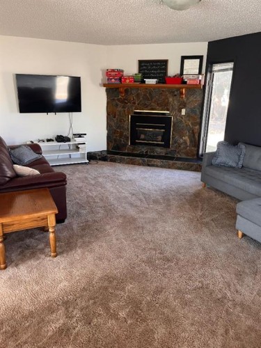409 Main Street, Milk River, AB - Indoor Photo Showing Living Room With Fireplace