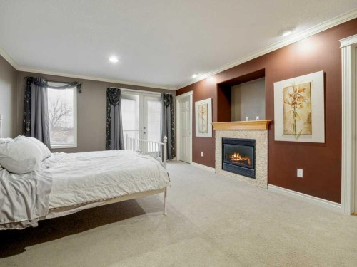 145 Canyon Close West, Lethbridge, AB - Indoor Photo Showing Bedroom With Fireplace