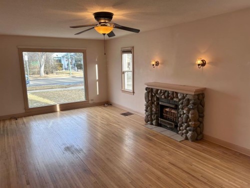 1212 7 Avenue South, Lethbridge, AB - Indoor Photo Showing Living Room With Fireplace