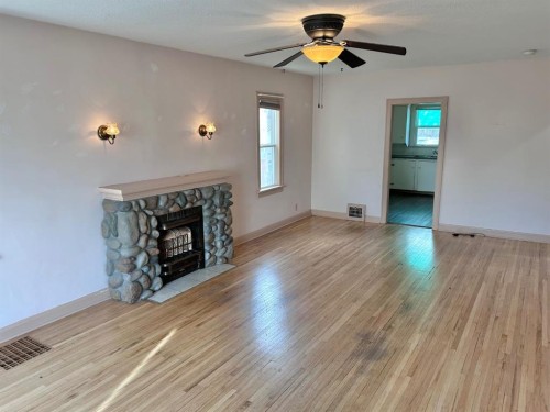 1212 7 Avenue South, Lethbridge, AB - Indoor Photo Showing Living Room With Fireplace