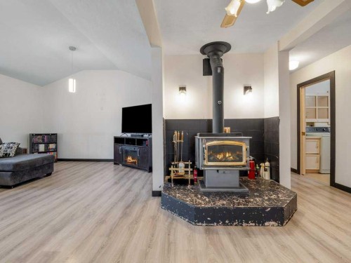 63004A 5 Highway, Welling, AB - Indoor Photo Showing Living Room With Fireplace