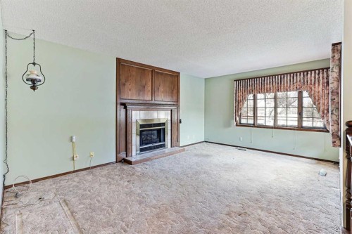 137 Edgewood Boulevard West, Lethbridge, AB - Indoor Photo Showing Other Room With Fireplace
