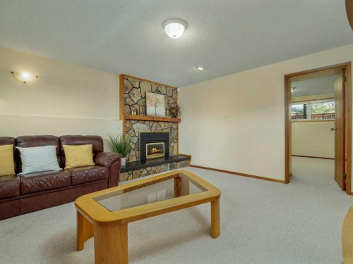 2017 16 Street North, Lethbridge, AB - Indoor Photo Showing Living Room With Fireplace