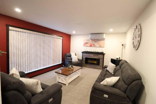 1124 2 Ave, Vauxhall, AB - Indoor Photo Showing Living Room With Fireplace