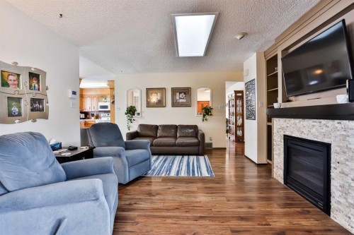 1813 Elm Road South, Lethbridge, AB - Indoor Photo Showing Living Room With Fireplace