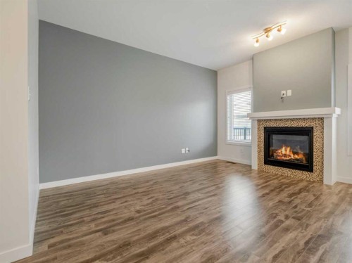 98 Moonlight Boulevard West, Lethbridge, AB - Indoor Photo Showing Living Room With Fireplace