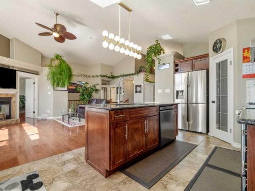 314 Coulee Springs Terrace, Lethbridge, AB - Indoor Photo Showing Kitchen With Fireplace