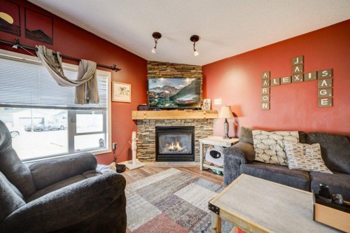 1414 84 Th Street, Coleman, AB - Indoor Photo Showing Living Room With Fireplace