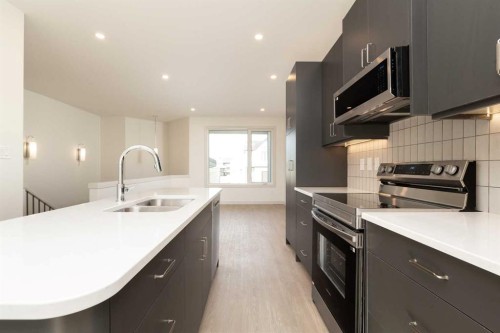 566 Malahat Green West, Lethbridge, AB - Indoor Photo Showing Kitchen With Double Sink With Upgraded Kitchen