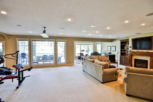 406 Stonecrest Terrace West, Lethbridge, AB - Indoor Photo Showing Gym Room With Fireplace