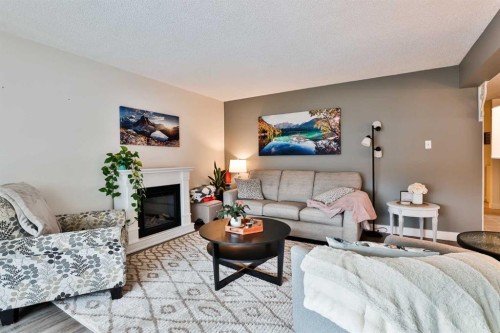 285 Jerry Potts Boulevard West, Lethbridge, AB - Indoor Photo Showing Living Room With Fireplace