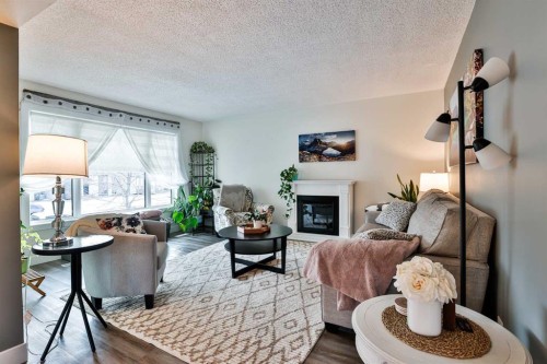 285 Jerry Potts Boulevard West, Lethbridge, AB - Indoor Photo Showing Living Room With Fireplace