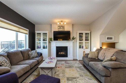 711 Moonlight Crescent West, Lethbridge, AB - Indoor Photo Showing Living Room With Fireplace