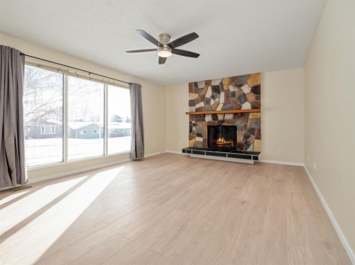 233 8 Street West, Cardston, AB - Indoor Photo Showing Living Room With Fireplace