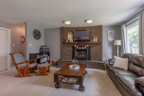 59 1 Street, Orton, AB - Indoor Photo Showing Living Room With Fireplace