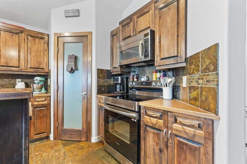 352 Tartan Circle West, Lethbridge, AB - Indoor Photo Showing Kitchen With Fireplace