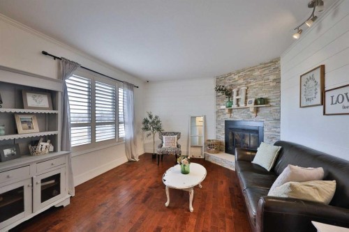 182 S 3 Street E, Magrath, AB - Indoor Photo Showing Living Room With Fireplace