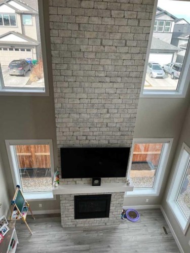 642 Moonlight Lane West, Lethbridge, AB - Indoor Photo Showing Other Room With Fireplace