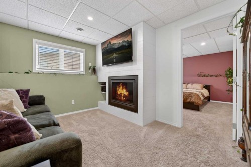 95 Stoney Crescent West, Lethbridge, AB - Indoor Photo Showing Other Room With Fireplace