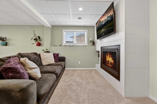 95 Stoney Crescent West, Lethbridge, AB - Indoor Photo Showing Living Room With Fireplace