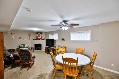 408 Thyrza Burkitt Link North, Lethbridge, AB - Indoor Photo Showing Dining Room With Fireplace