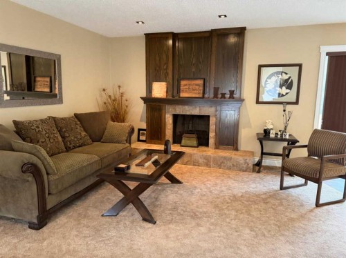 5120 48 Street, Taber, AB - Indoor Photo Showing Living Room With Fireplace