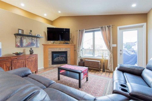 73 Heritage Circle West, Lethbridge, AB - Indoor Photo Showing Living Room With Fireplace