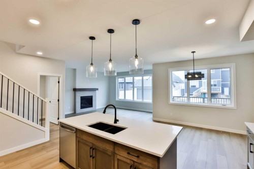 668 Devonia Road West, Lethbridge, AB - Indoor Photo Showing Kitchen With Fireplace With Double Sink