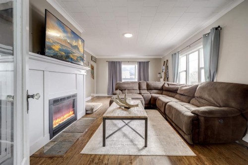 8301 18 Avenue, Coleman, AB - Indoor Photo Showing Living Room With Fireplace