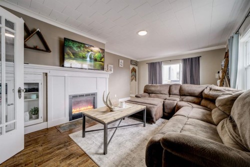 8301 18 Avenue, Coleman, AB - Indoor Photo Showing Living Room With Fireplace