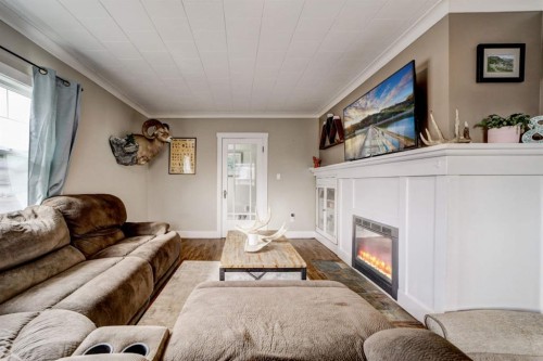 8301 18 Avenue, Coleman, AB - Indoor Photo Showing Living Room With Fireplace