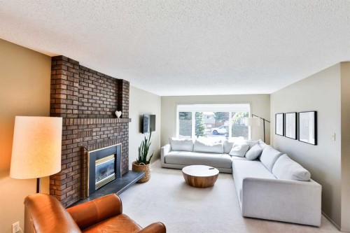 104 Elm Crescent South, Lethbridge, AB - Indoor Photo Showing Living Room With Fireplace