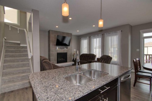 559 Moonlight Lane West, Lethbridge, AB - Indoor Photo Showing Kitchen With Fireplace With Double Sink